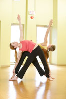 Two people doing yoga